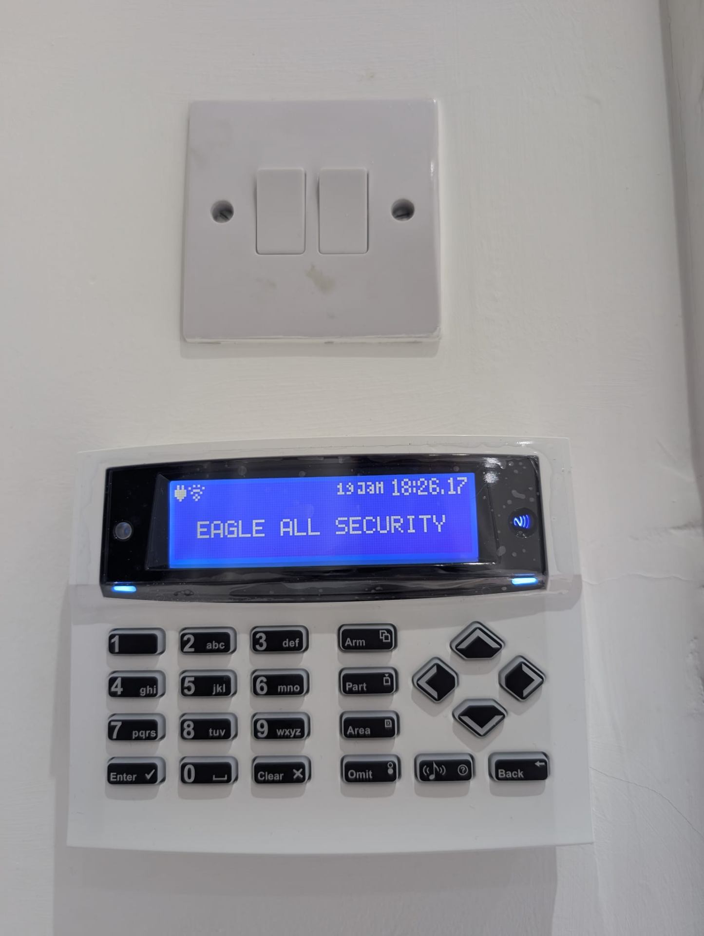 Professional alarm control panel installed in a London home