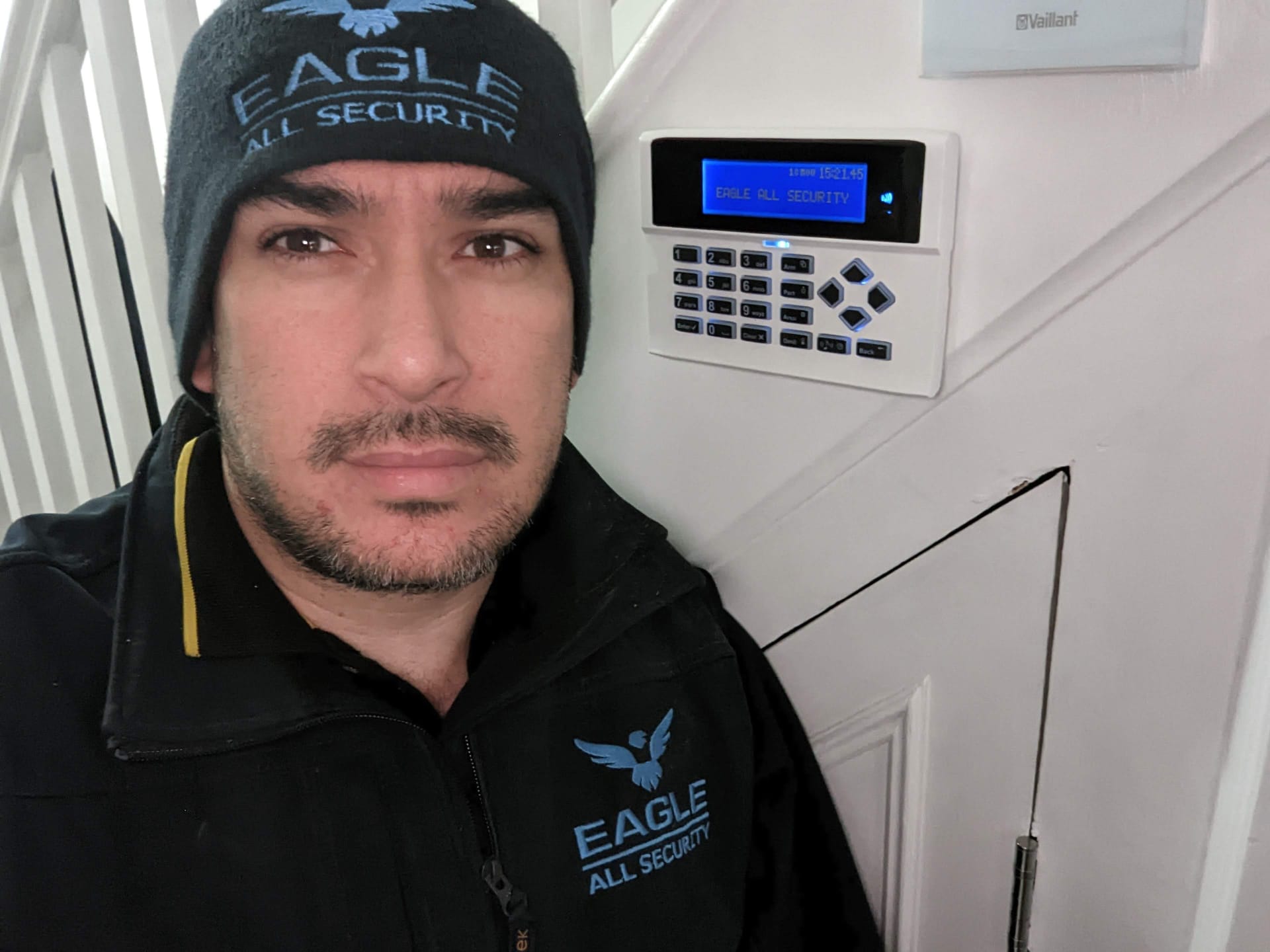 Eagle All Security engineer next to completed alarm installation